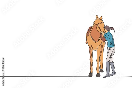 One single line drawing young horse rider woman hugging and rubbing her horsehair at stable vector illustration. Equestrian sport show competition concept. Modern continuous line draw design