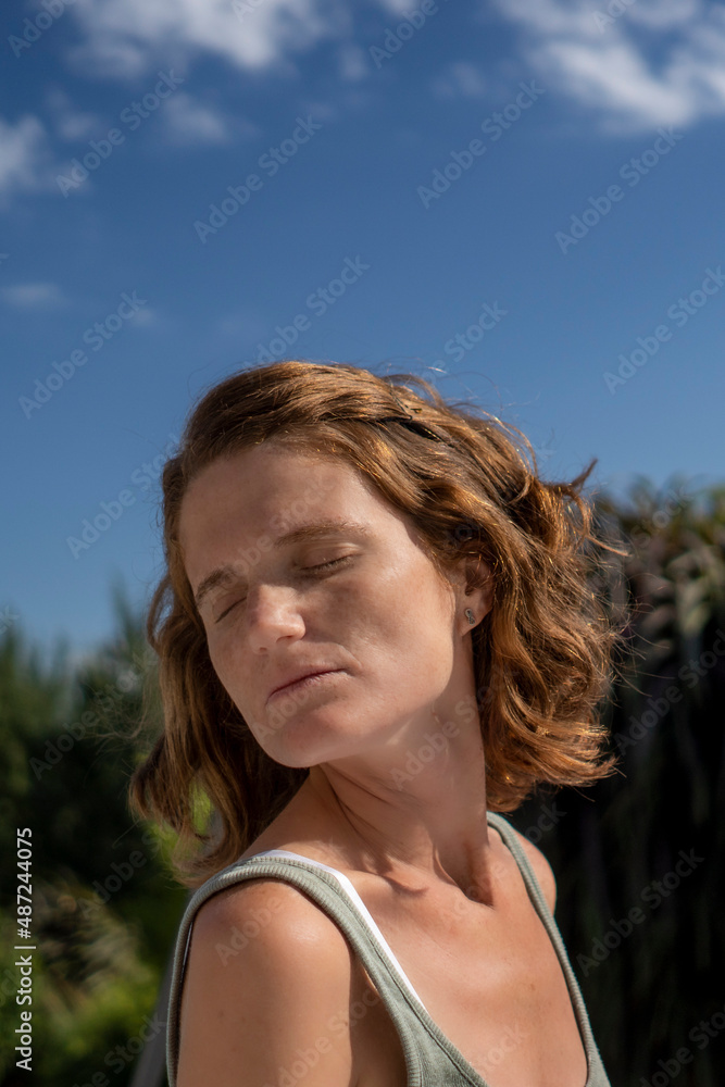 Young redhead woman exercising outdoors Young redhead woman exercising outdoors