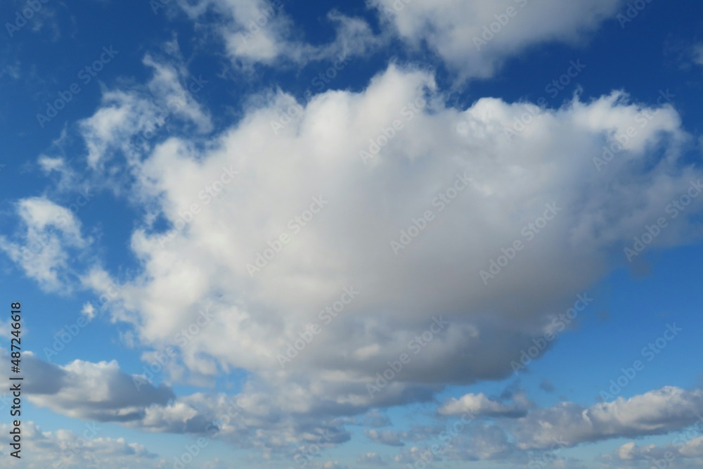 Beautiful big fluffy cloud in blue sky, natural clouds background Beautiful big fluffy cloud in blue sky, natural clouds background