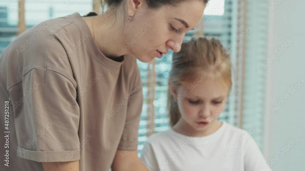 Mom And Seven-Year-Old Daughter Make Gingerbread Cookies In Molds At Home. Daughter Helps Her Mother Baking Christmas Cookies At Home Mom And Seven-Year-Old Daughter Make Gingerbread Cookies In Molds At Home. Daughter Helps Her Mother Baking Christmas Cookies At Home