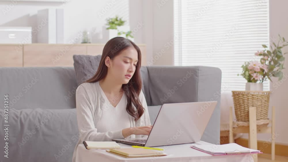 Busy mother working with computer laptop and her daughter playing makes noise disturbs mom work.Freelancer mom working on laptop at home with children noise stressed and headache Busy mother working with computer laptop and her daughter playing makes noise disturbs mom work.Freelancer mom working on laptop at home with children noise stressed and headache