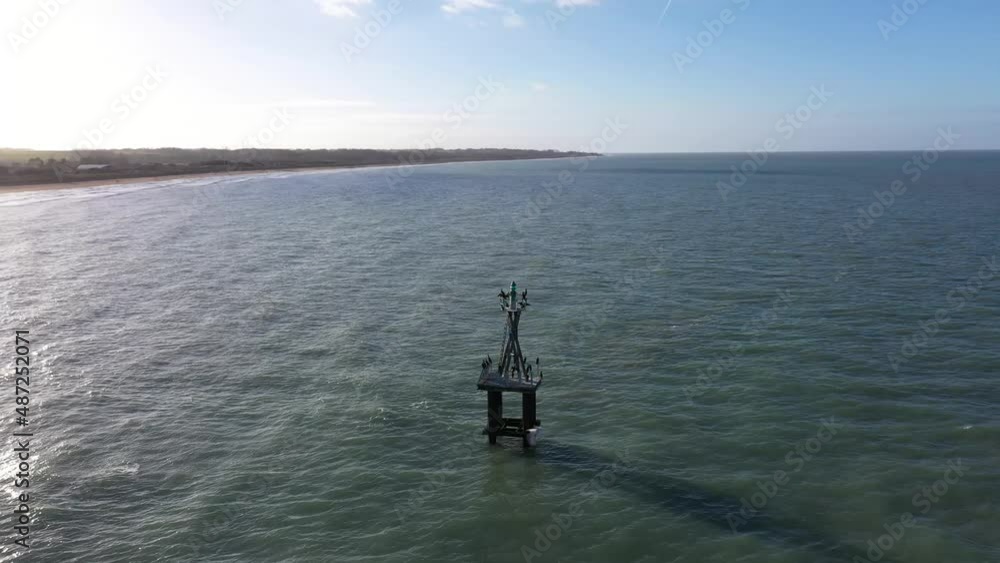 drone shot of a marine beacon in courseulles-sur-mer on a beautiful sunseet drone shot of a marine beacon in courseulles-sur-mer on a beautiful sunseet