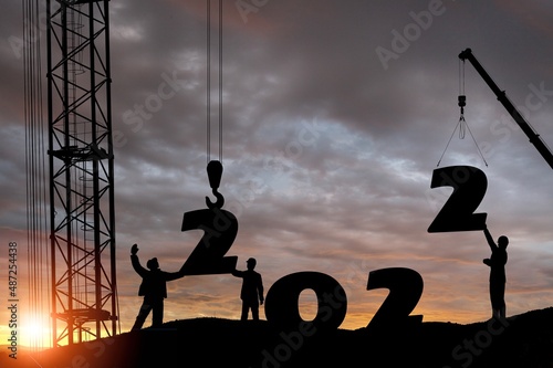 Silhouette staff works as a to prepare to welcome the new year 2022 on construction site