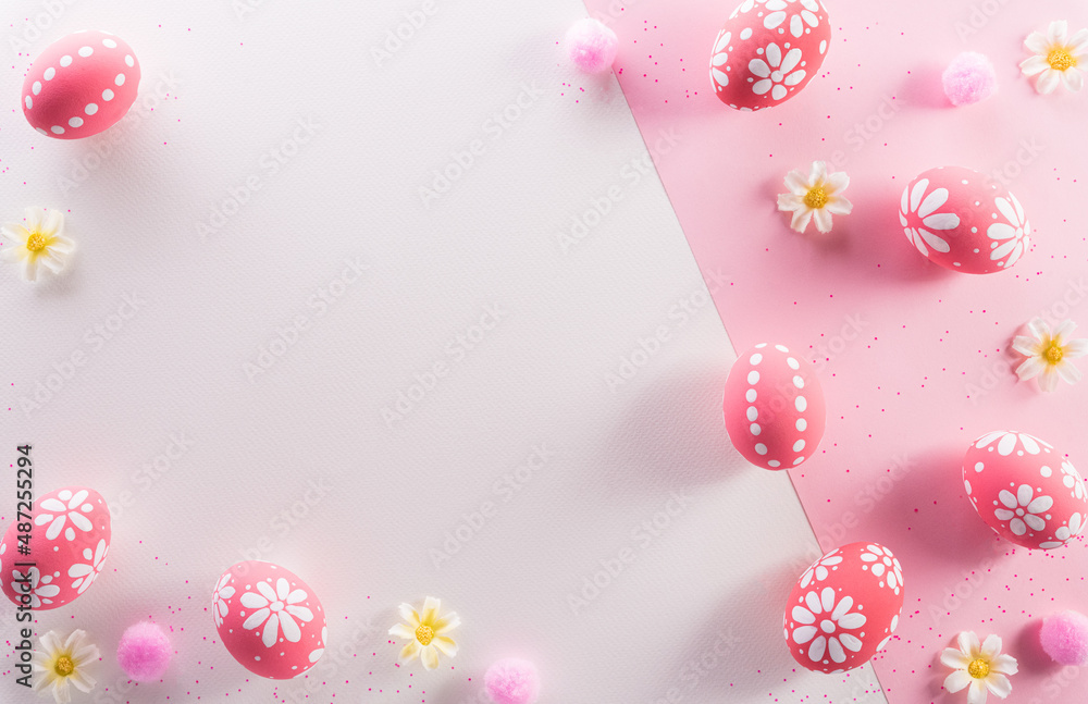 Happy easter decoration concept. Colourful Easter eggs with flowers on pink and white background.