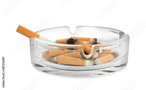Glass ashtray with cigarette stubs isolated on white
