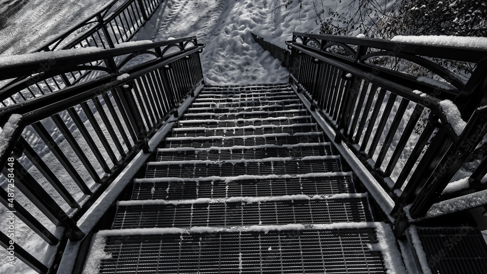 Fototapeta premium Snow covered urban stairs with snow in black and white