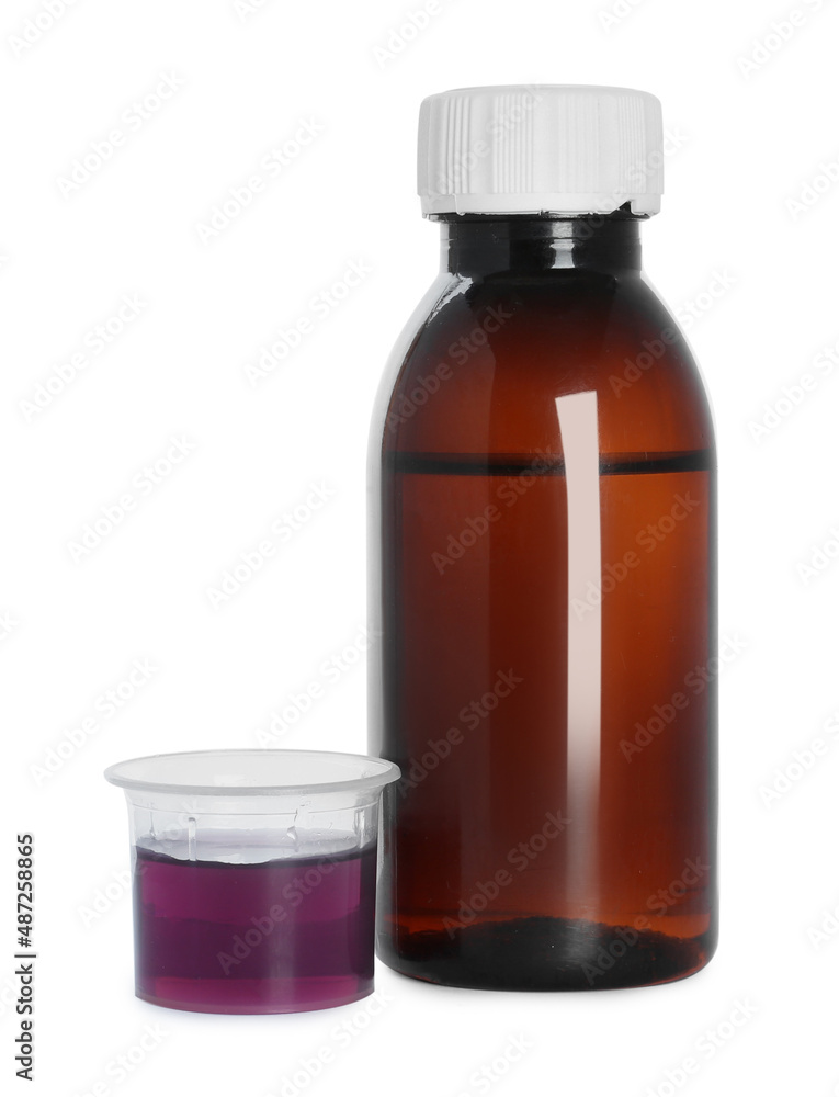 Bottle of cough syrup and measuring cup on white background Bottle of cough syrup and measuring cup on white background