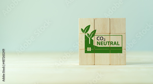 Carbon neutral sustainable development concept. Green industry. Net zero greenhouse gas emissions target 2050. Climate neutral long term strategy. Wooden cube with carbon neutral, green factory icon.