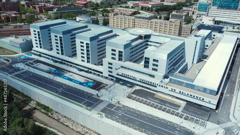 Aerial view of a big white and blue public hospital in Salamanca, Castilla y León, Spain. Modern square architecture. Drone shot. Aerial view of a big white and blue public hospital in Salamanca, Castilla y León, Spain. Modern square architecture. Drone shot.