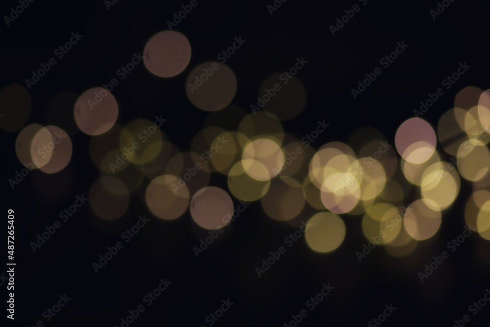 Fototapeta premium Abstract bokeh background. Golden bokeh circles on dark blue background. Layer overlay.