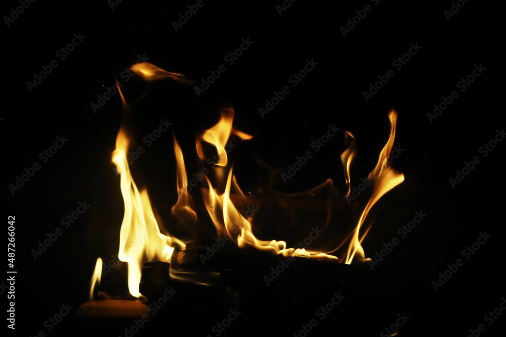 The flames of burning wood in the fireplace of a country house. Coals and sparks.
