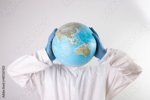 Doctor holding the planet Earth instead of head.