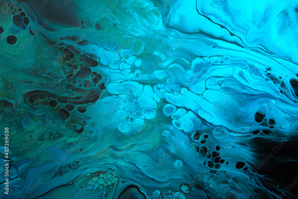 Fluid Art. Green and fluorescent blue abstract wave swirls on black background. Marble effect background or texture