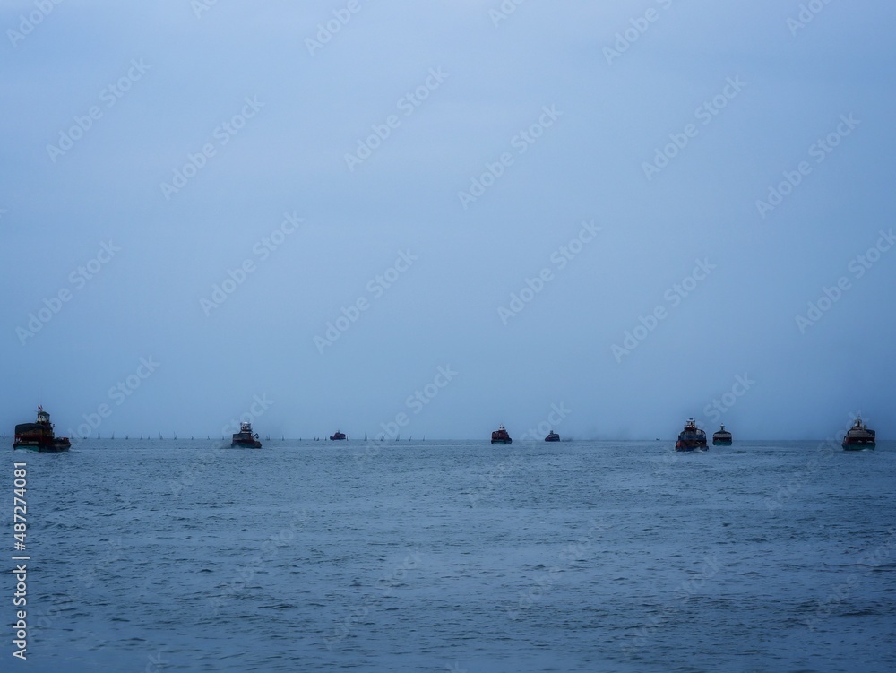 a fleet of fishing boat going out to open sea