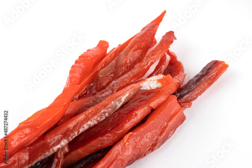 Pieces of dried and smoked fish from red salmon species. The concept of snacks for beer. Fish strips for beer