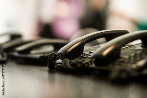 Shallow depth of field (selective focus) details with analogue telephones with secure connections in a high security public institution. photo
