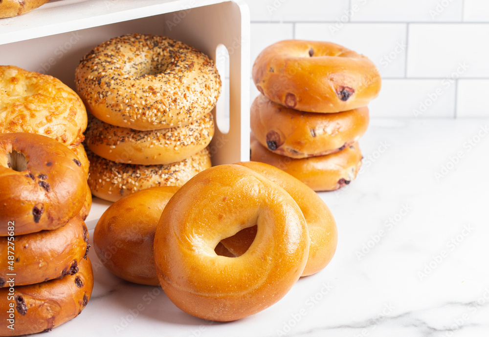Stacks of Various Flavors of Bagels on a Counter