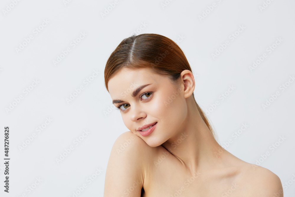 young woman smiling woman bare shoulders clean skin charm Model light background young woman smiling woman bare shoulders clean skin charm Model light background
