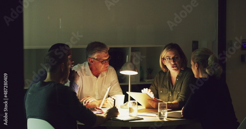 Putting in the effort to power through their deadlines. 4k video of a group of businesspeople working late in an office.