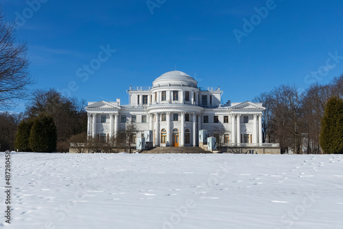 Elagin Palace in front of a snowy field among trees early spring (St. Petersburg, Russia)