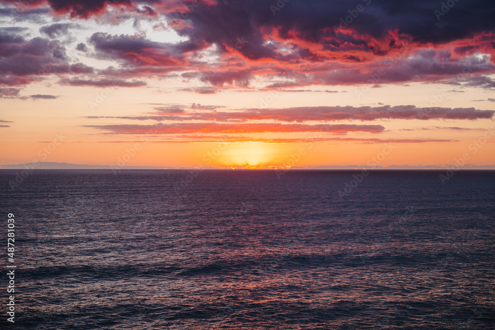 Colorful sunset over the ocean with views of the horizon
