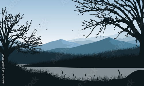 Incredible panorama of mountains and lakes with blue sky with fantastic dry tree silhouettes