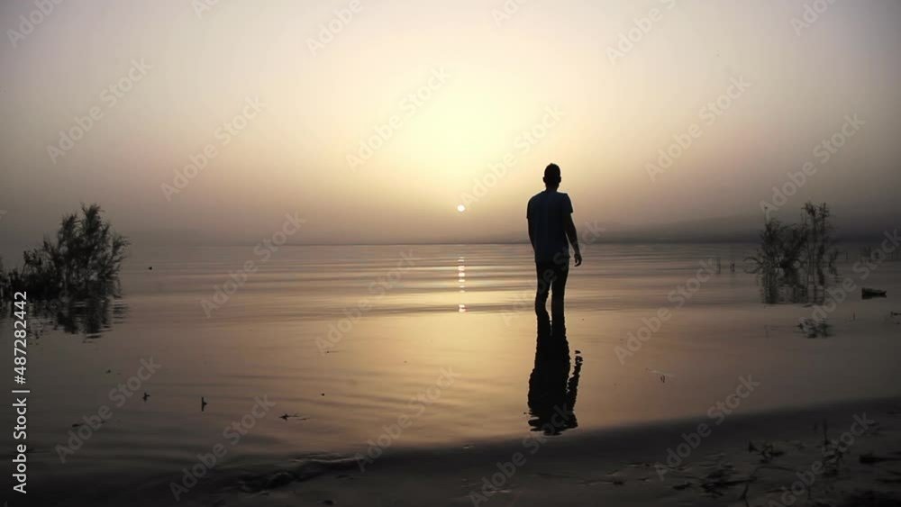 Pondering shadow reflections at Galileo sea Israel Golan heights Pondering shadow reflections at Galileo sea Israel Golan heights