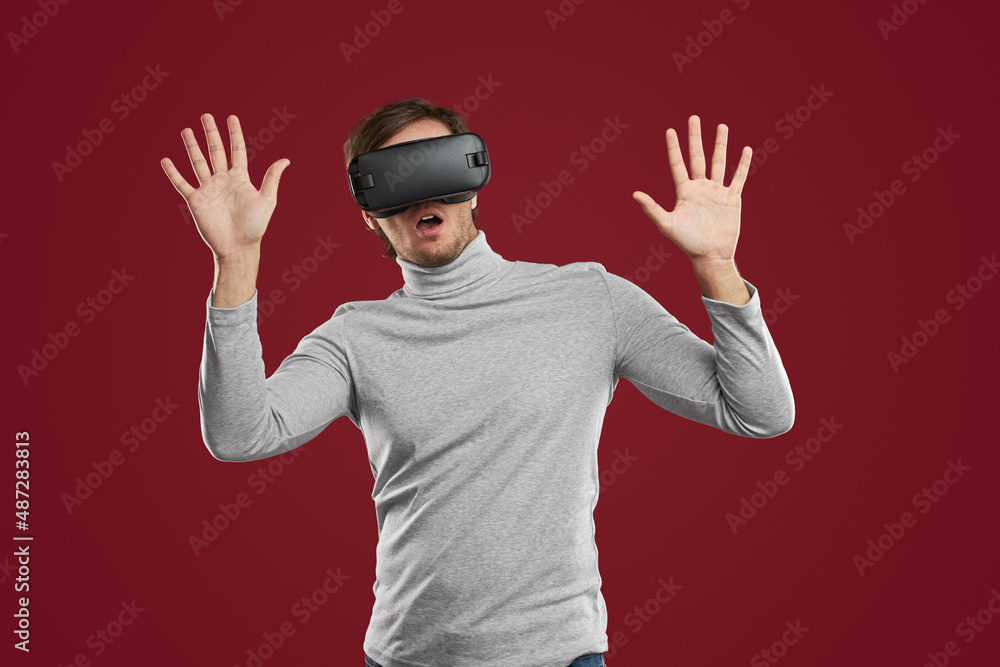Fototapeta premium Scared man playing videogame in virtual reality