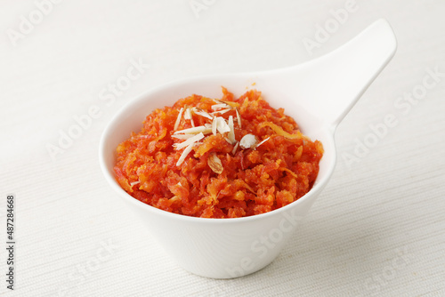 Gajar ka halwa is a carrot-based sweet dessert pudding from India. Garnished with Cashew/almond nuts  photo