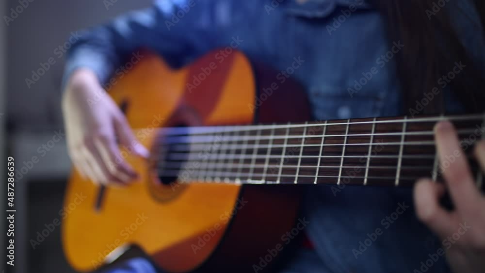 Musician playing on acoustic guitar at home Musician playing on acoustic guitar at home