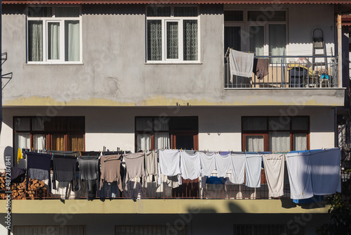 A gray house in an turkish  city, laundry is drying on a rope photo