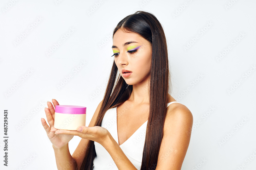 attractive girl posing cream jar cosmetics isolated background unaltered attractive girl posing cream jar cosmetics isolated background unaltered