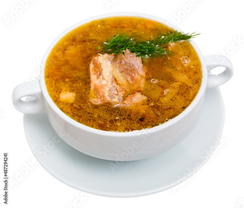 Soup of cabbage with boiled vegetables and pork broth, served in bowl. Isolated over white background