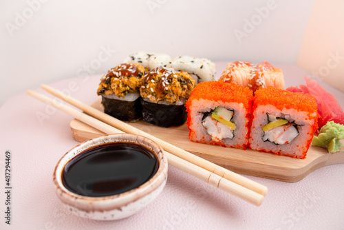 set of rolls on a wooden board and bamboo sticks