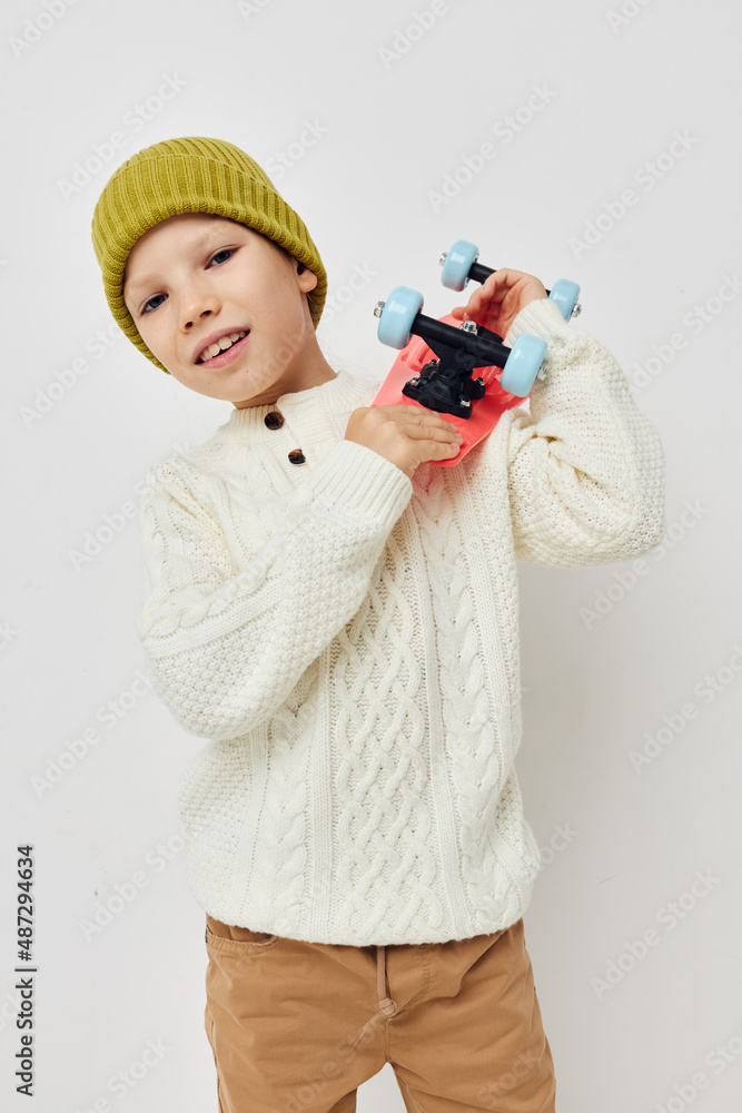 little girl in hats with a skateboard in their hands light background little girl in hats with a skateboard in their hands light background