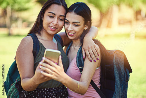 Theres always time to snap a selfie. Cropped shot of two young friends taking a selfie together outside.