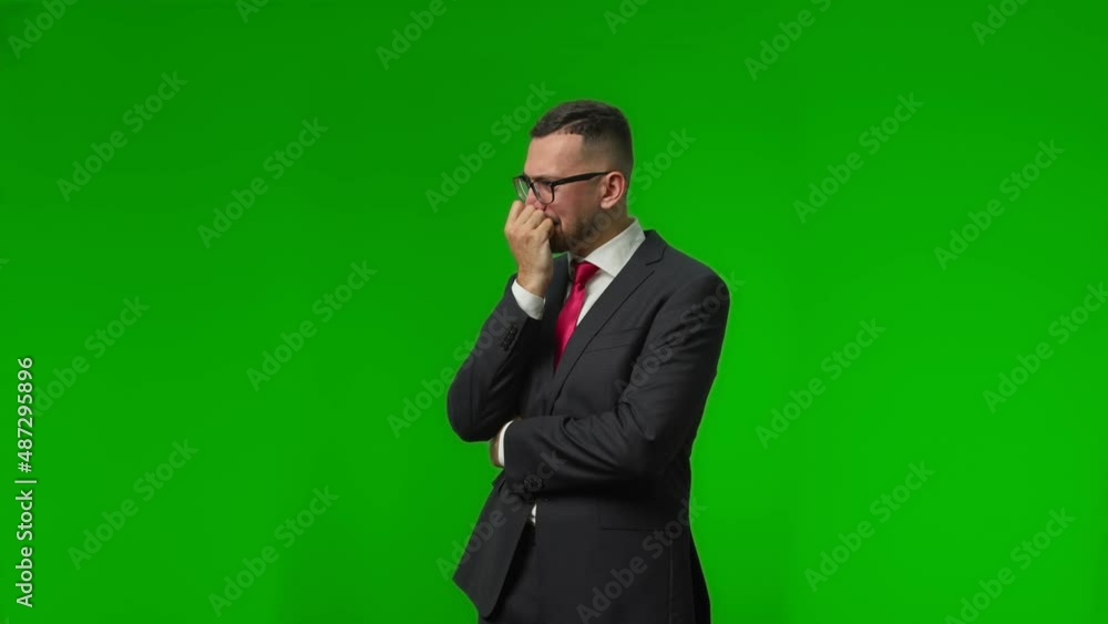 Serious young concentrated businessman involved in the process of intensive thinking fidgeting nervously with his fingers Serious young concentrated businessman involved in the process of intensive thinking fidgeting nervously with his fingers