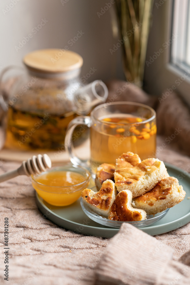 cup of tea and cookies. composition with a glass teapot and glasses filled with tea with lemon cup of tea and cookies. composition with a glass teapot and glasses filled with tea with lemon