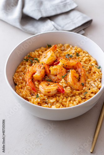 Risotto with shrimps, tomatoes and thyme. Italian food.