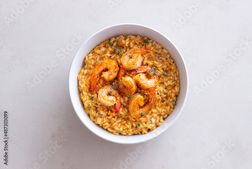Risotto with shrimps, tomatoes and thyme. Italian food.