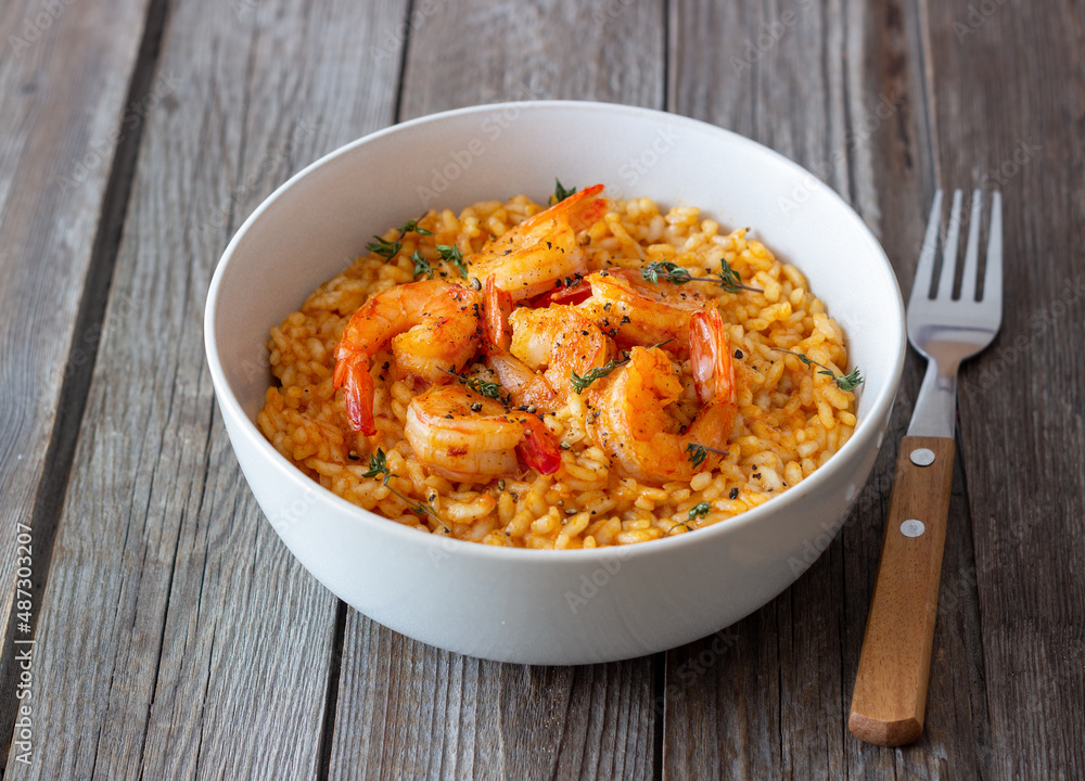 Risotto with shrimps, tomatoes and thyme. Italian food. Risotto with shrimps, tomatoes and thyme. Italian food.