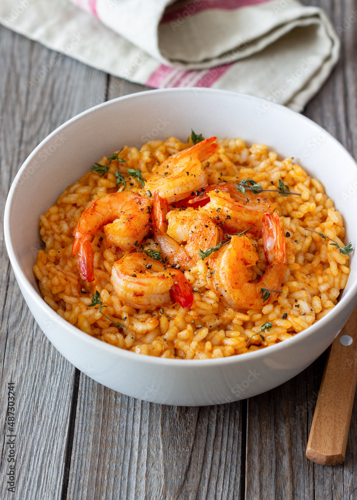 Risotto with shrimps, tomatoes and thyme. Italian food. Risotto with shrimps, tomatoes and thyme. Italian food.