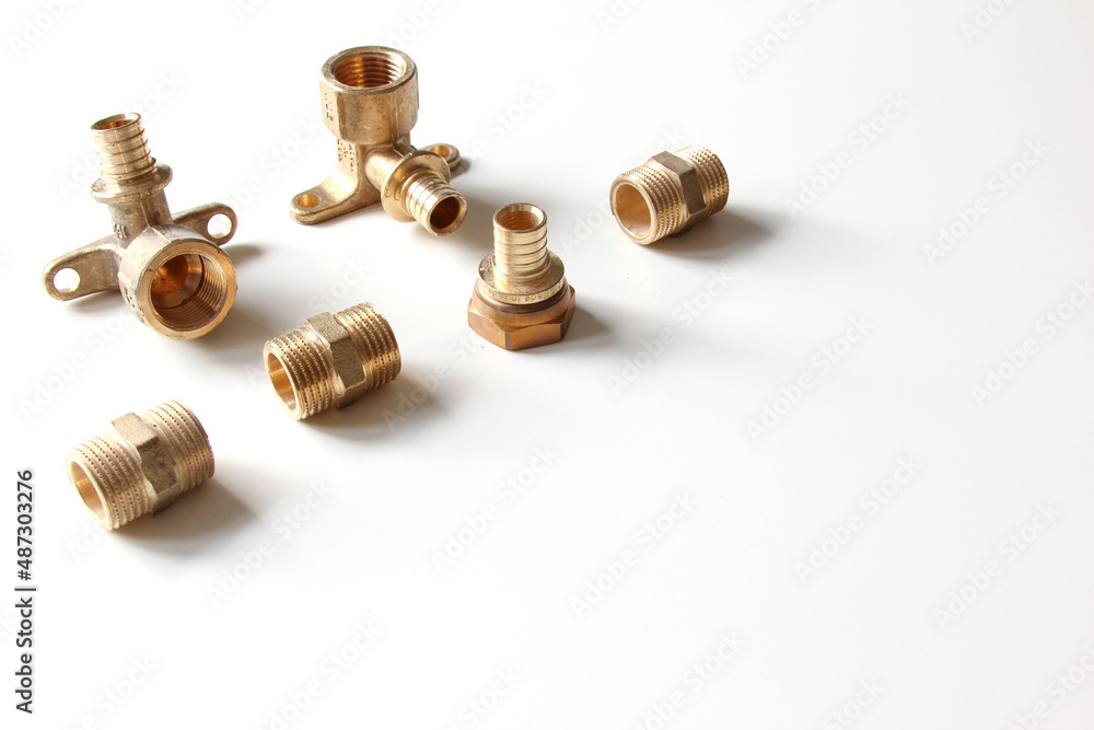 Plumbing faucet and brass fittings on the white background repairing or replacing different equipment