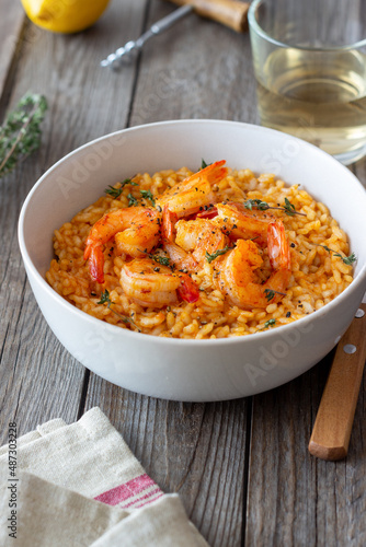Risotto with shrimps, tomatoes and thyme. Italian food.