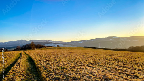Sunset over a field in the Liberec region with a view of Ještěd, Czech Republic