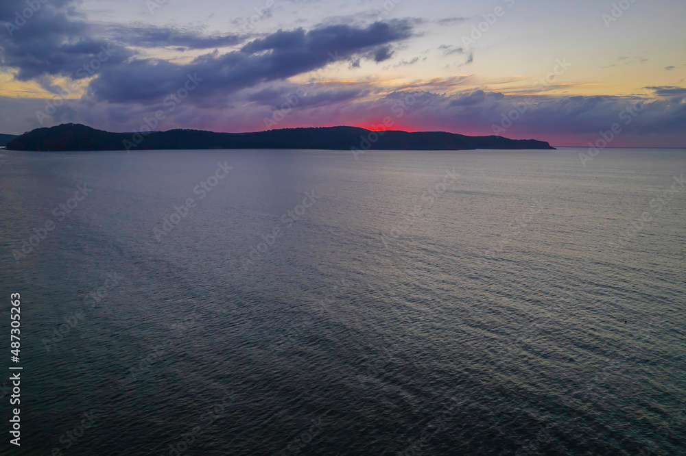 Aerial sunrise seascape with  a few rain clouds