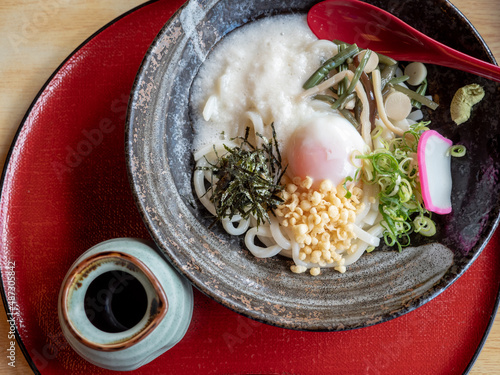 Japanese bukkake udon bowl over red tray