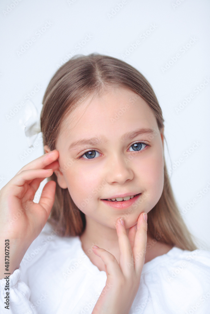 A beautiful cheerful little girl about 10 years old in a beautiful dress on an isolated white background.A place for your text. A beautiful cheerful little girl about 10 years old in a beautiful dress on an isolated white background.A place for your text.