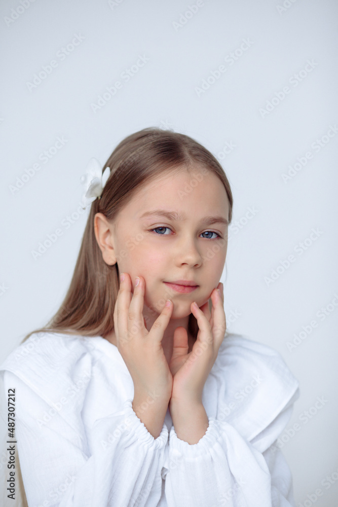 A beautiful cheerful little girl about 10 years old in a beautiful dress on an isolated white background.A place for your text. A beautiful cheerful little girl about 10 years old in a beautiful dress on an isolated white background.A place for your text.