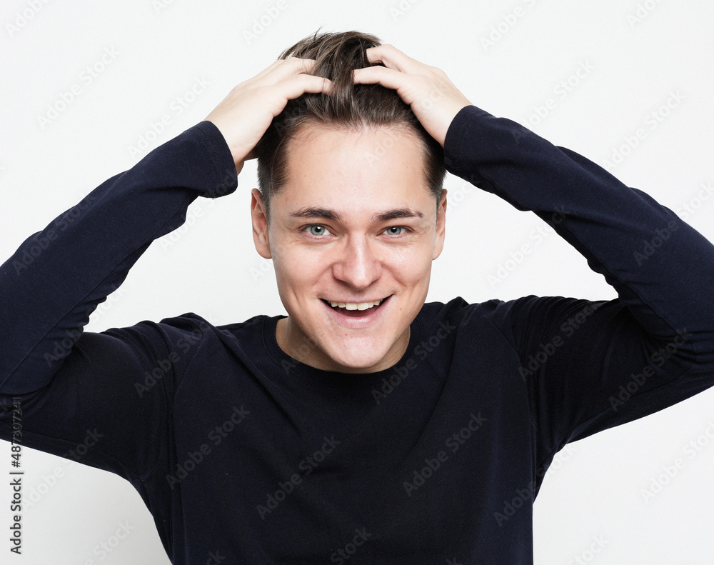 Close-up portrait of handsome adult man with beaming smile, looking camera satisfied, feel upbeat and enthusiastic